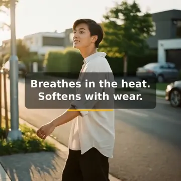 A man in a white linen shirt walking down a sunny street, caption: Breathes in the heat. Softens with wear.